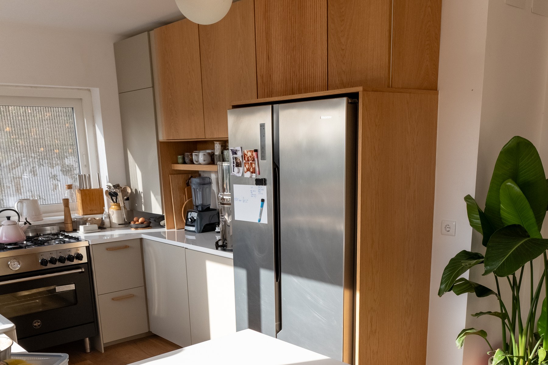 Real oak kitchen fronts and tall cabinets fitted around an existing kitchen